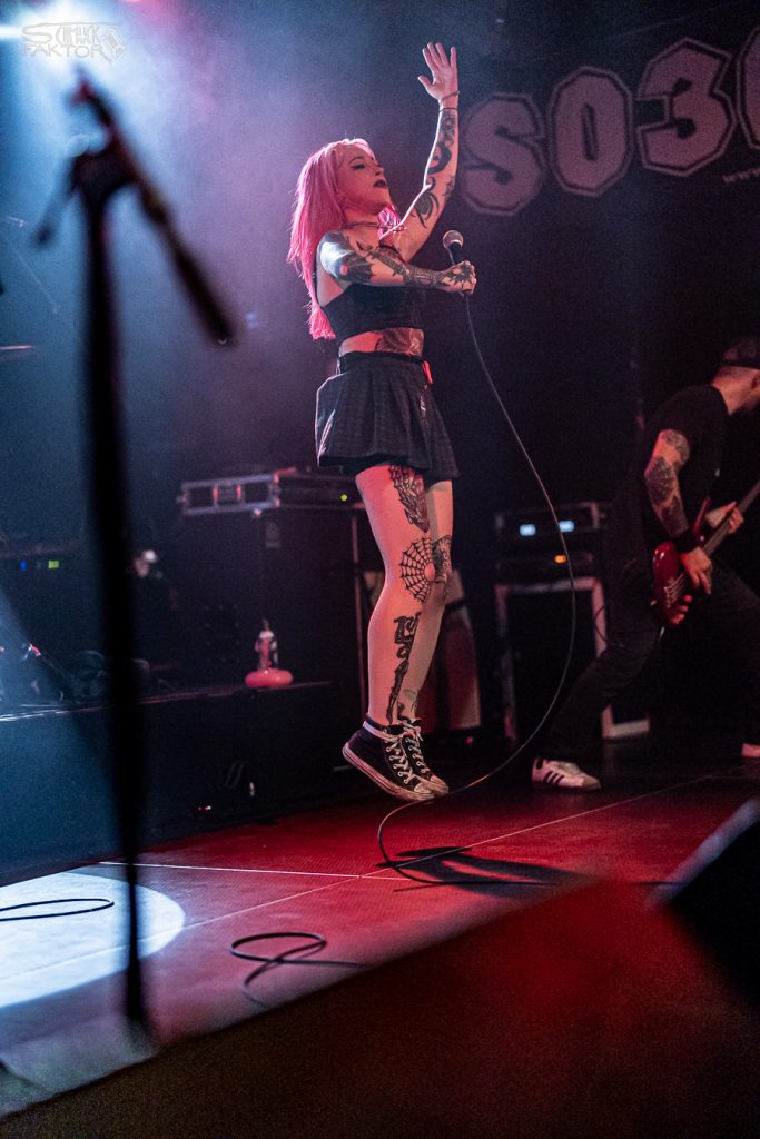 Interview mit Gero / Female Fronted is not a Genre Festival 2026 21 Hoher Sprung! Mit beiden Füßen hebt die Sängerin vor dem Schriftzug SO36 vom Boden ab und reckt den Arm in die Luft, die andere Hand hält das Mikrofon